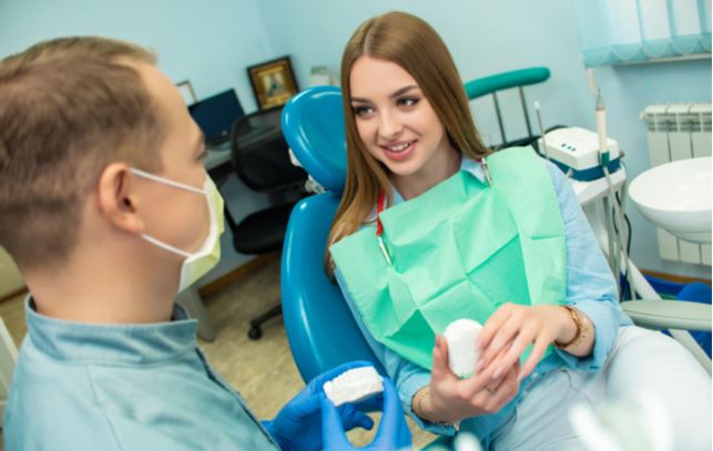 Young woman consulting with her dentist about options available for sedation dentistry