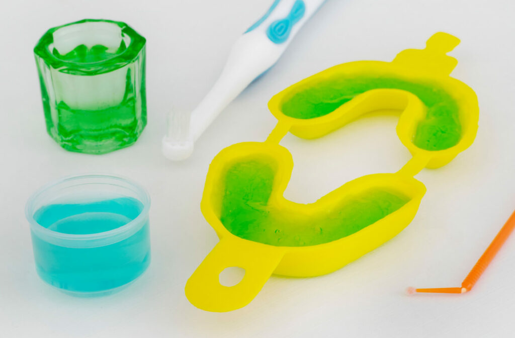 Tubs and trays of fluoride paste that could be used as treatment at your dental appointment