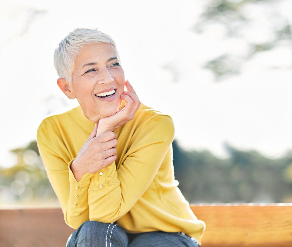A person with a beautiful smile sitting outdoors
